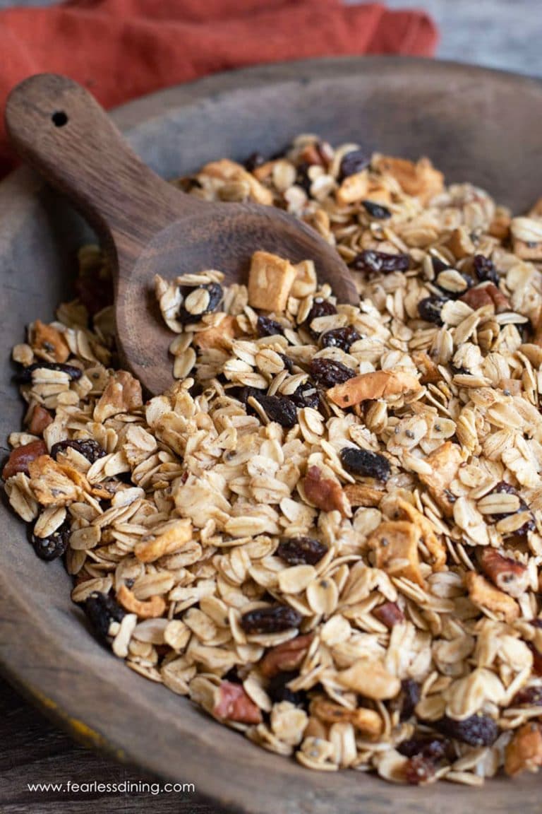 A wooden serving bowl filled with granola.