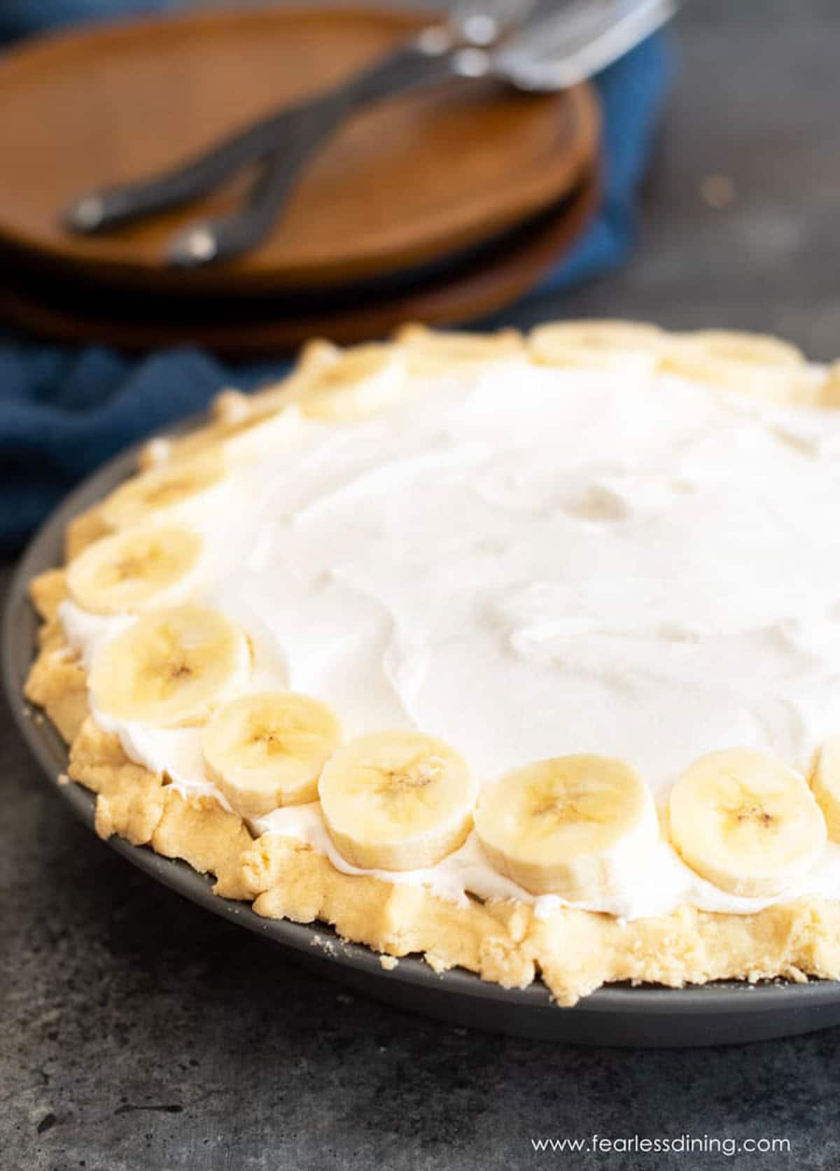 A whole gluten free banana cream pie on a table.