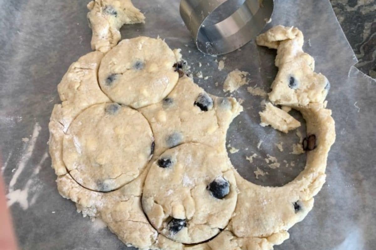 Cutting scones out of the dough.