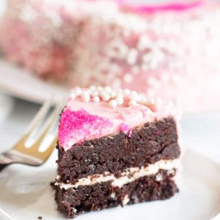 a slice of gluten free brownie layer cake on a plate