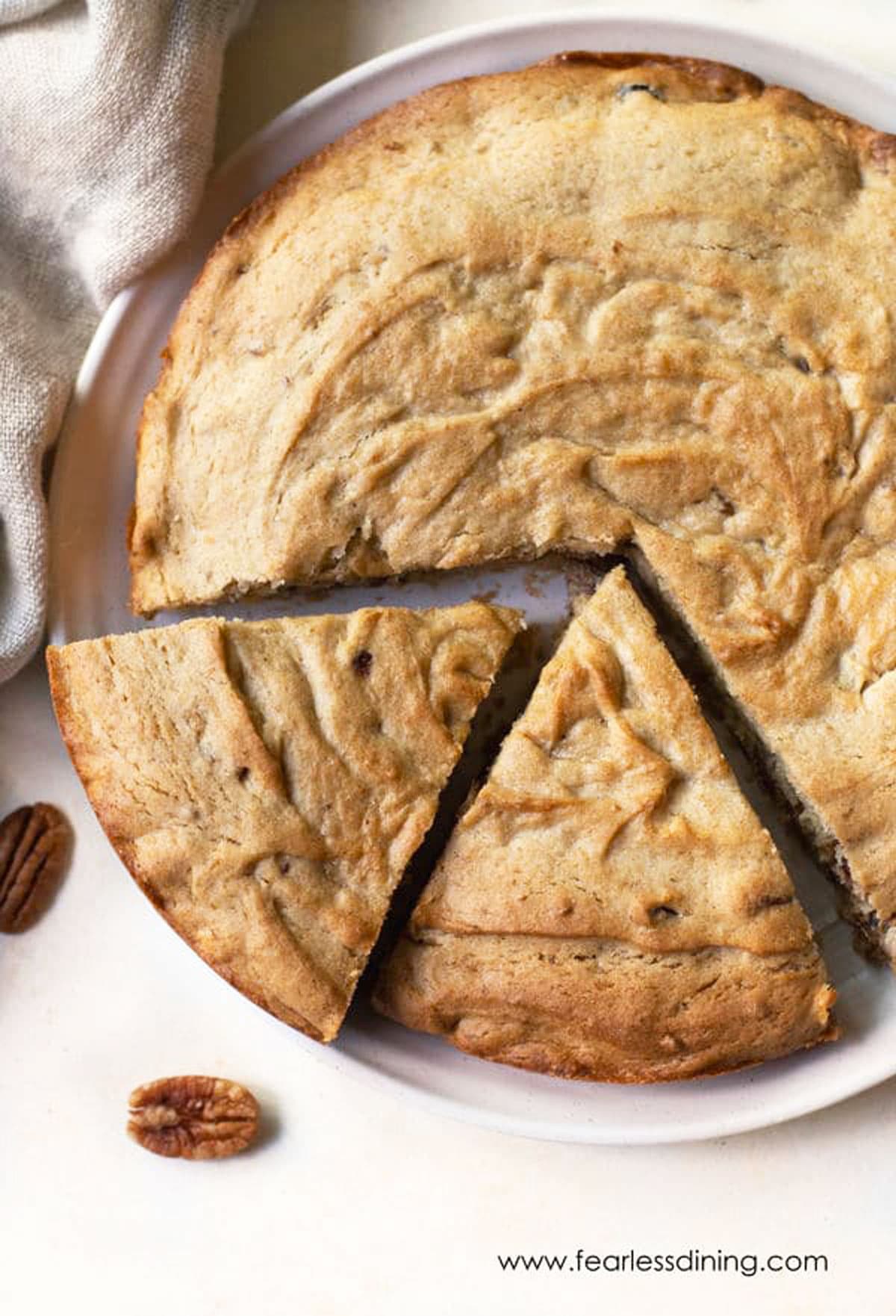 The top view of a round gluten cake with two slices cut.