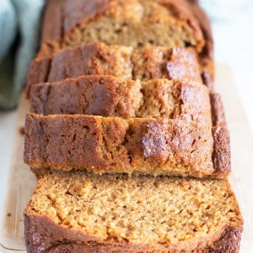 A sliced gluten free honey cake loaf on a cutting board.