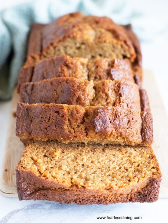 A sliced gluten free honey cake loaf on a cutting board.