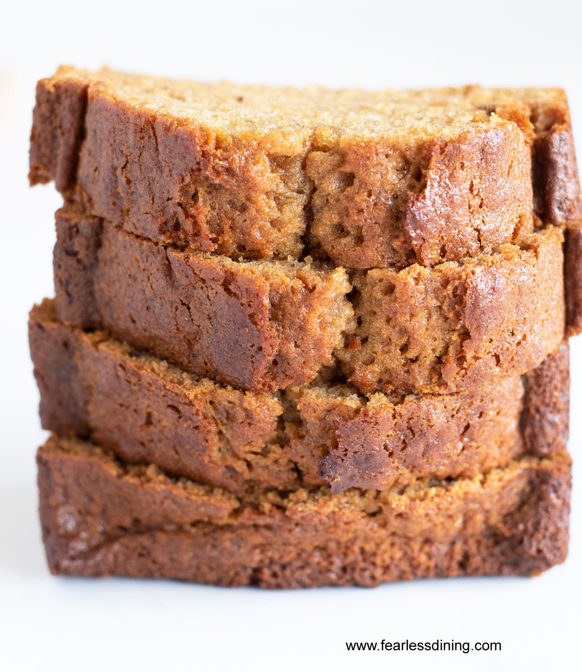 A stack of four slices of honey cake.