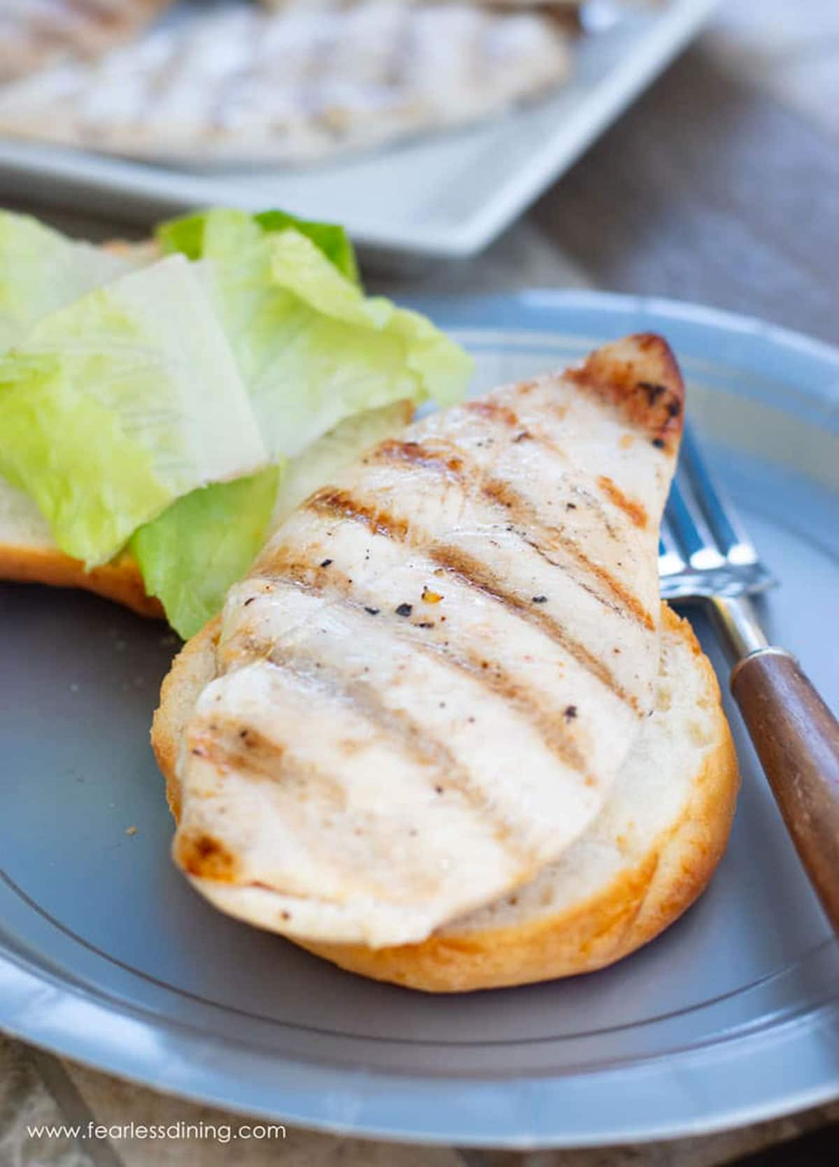 A grilled chicken breast on a gluten free bun.