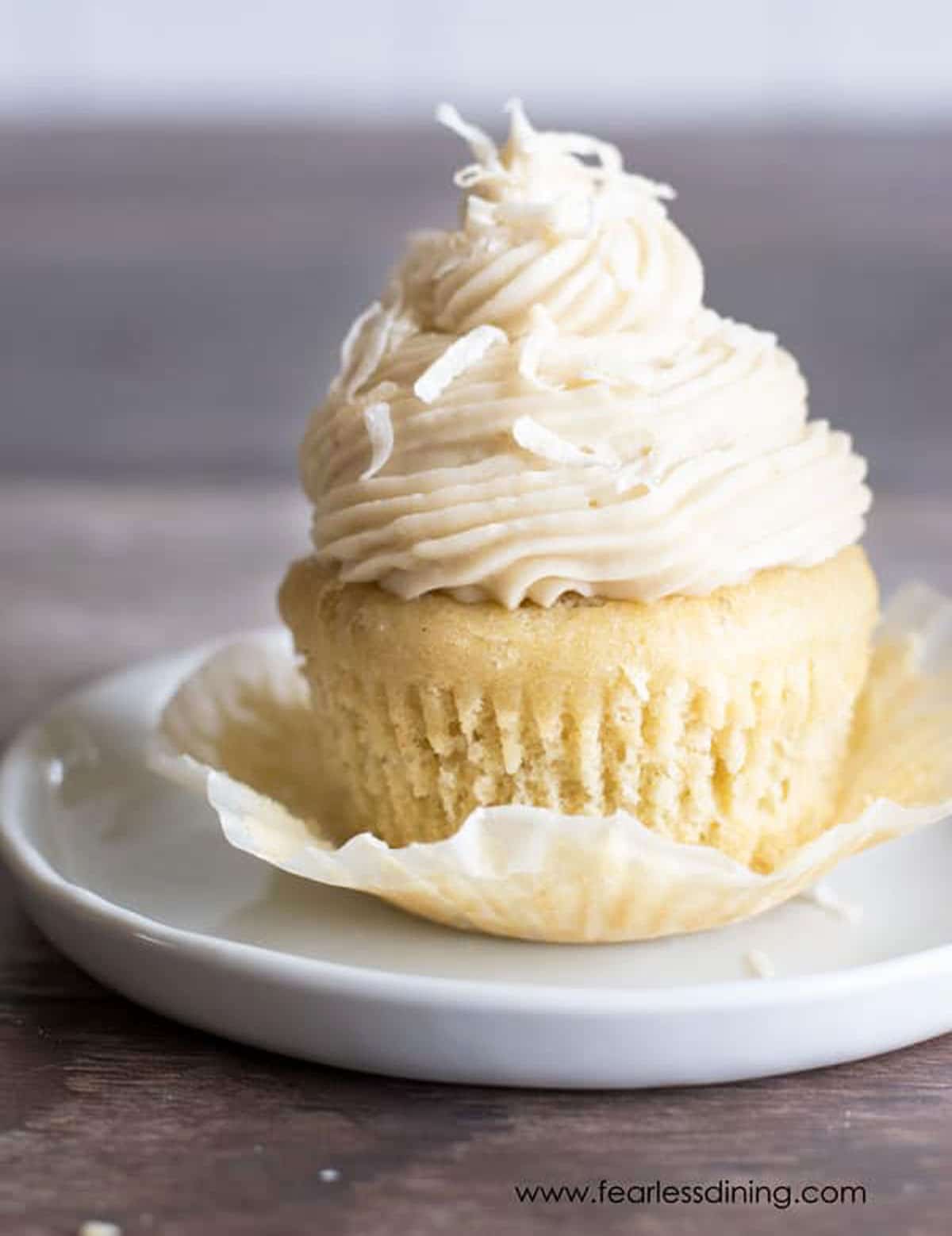 A cupcake with the cupcake wrapper peeled back.