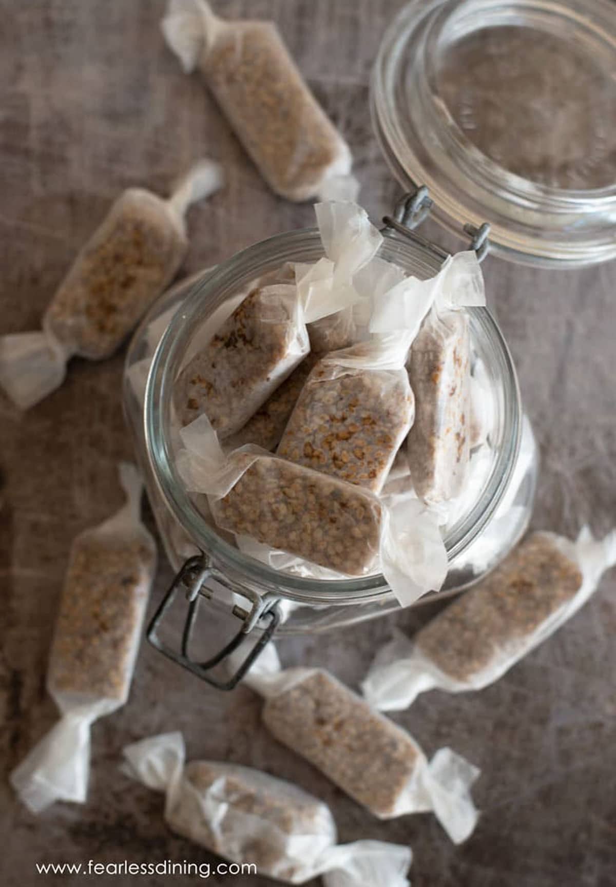 A gift jar filled with wrapped honey sesame candies.