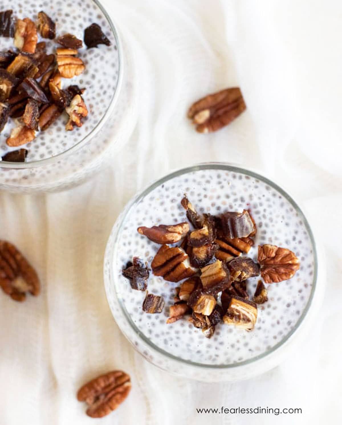 Two glasses of vanilla chia pudding on a table.