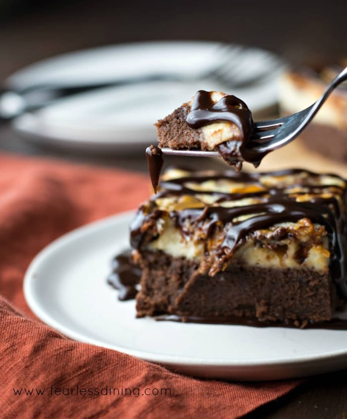 A forkful of brownie cheesecake.