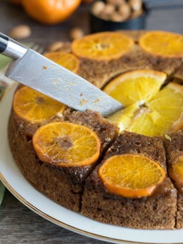 cutting the orange cake with a knife