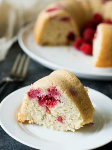 A slice of vanilla raspberry bundt cake on a small white plate.