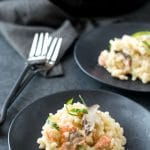 Two black plates with gluten free smoked salmon risotto.