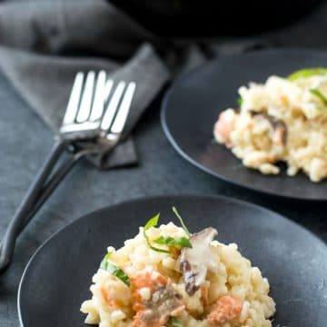 two black plates with gluten free risotto