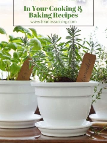 white flower pots with fresh herbs growing in them