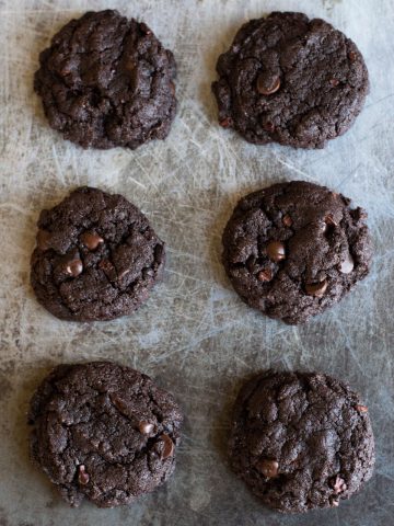 baked espresso cookies lined up on a cookie sheet
