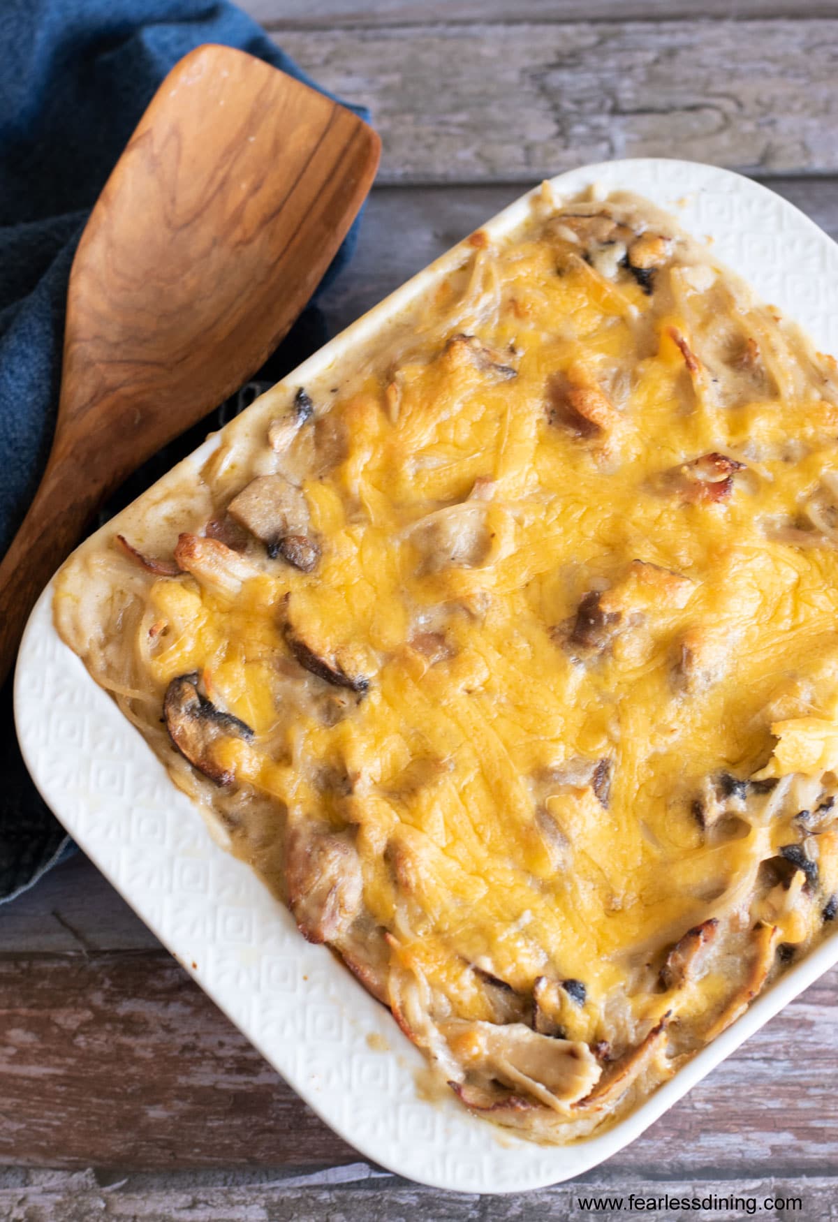 A top view of a baked chicken tetrazzini in a white casserole dish.