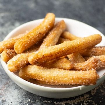 A big bowl full of fried churros.