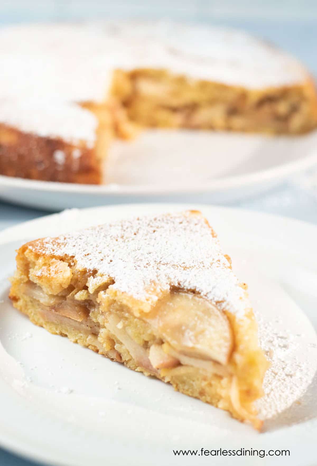 A slice of gluten free Passover apple cake on a white plate.