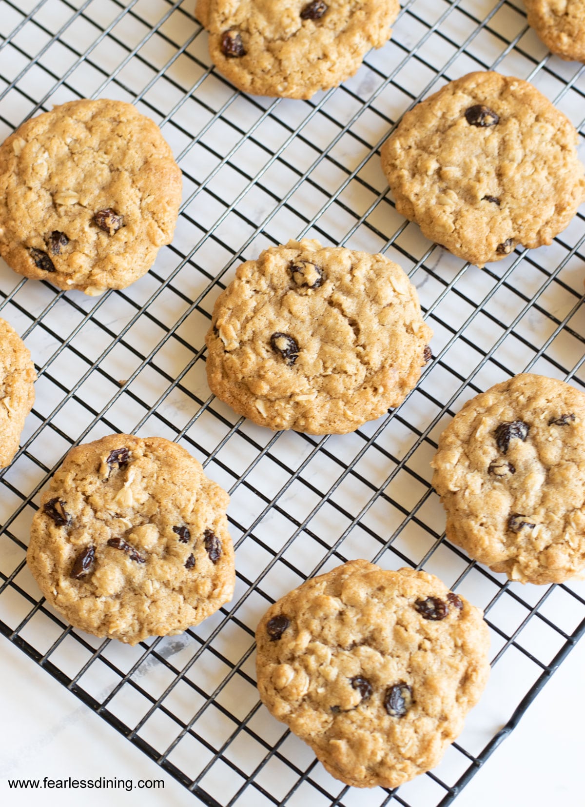 Oatmeal raisin cookies on a cooling rack.