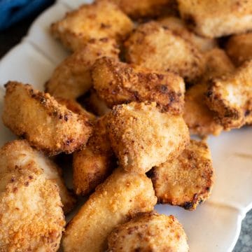 A platter filled with air fried gluten free chicken nuggets.