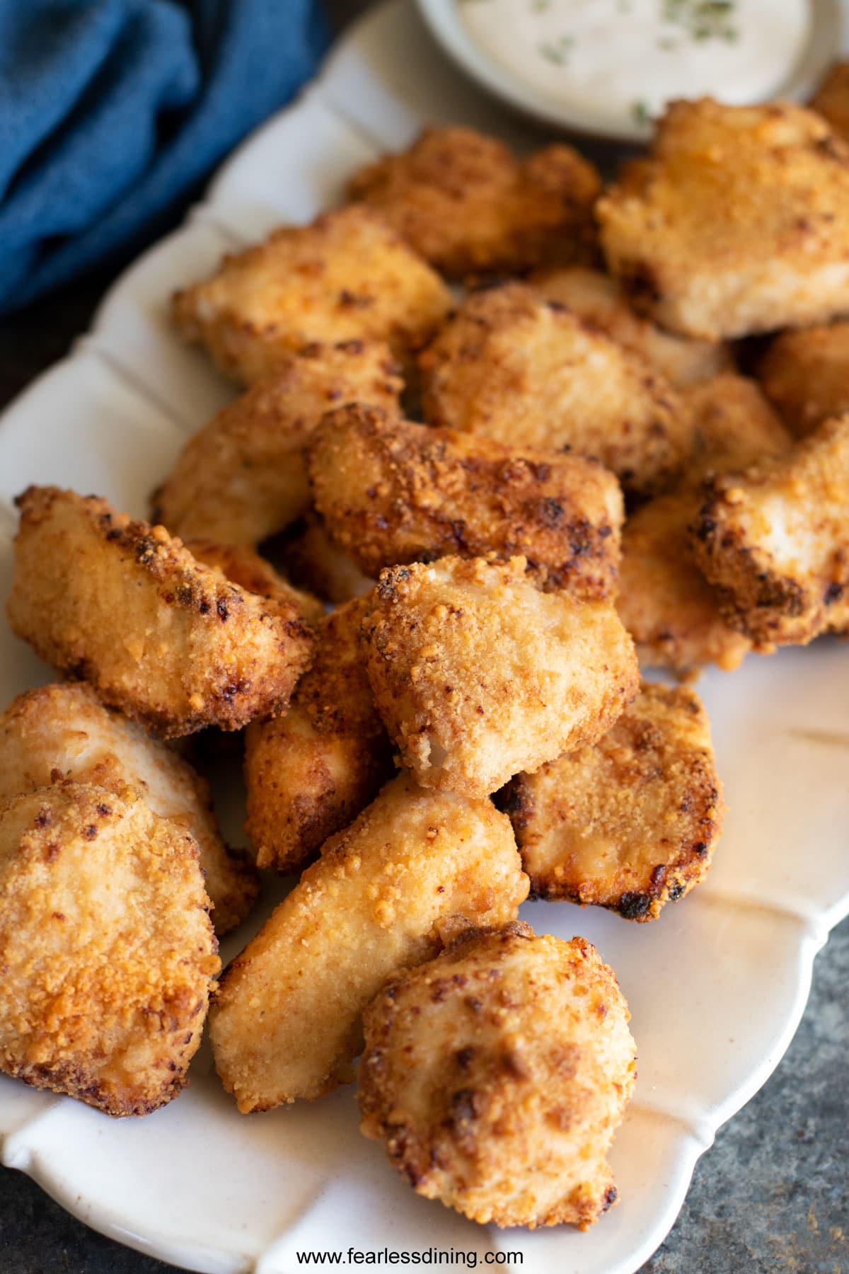 A platter filled with air fried gluten free chicken nuggets.