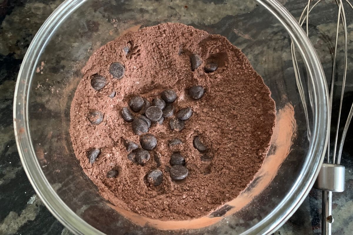 The dry mixed mug brownie ingredients in a glass bowl.