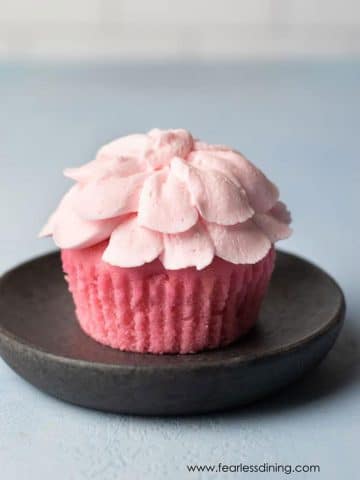 a pink lemonade cupcake frosted like a flower