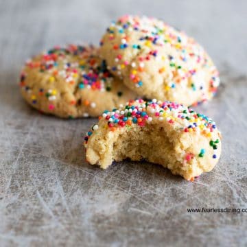 sprinkle cookies on a cookie sheet. One has a bite taken out