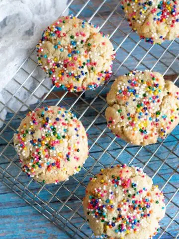 a cooling rack with sprinkles cookies