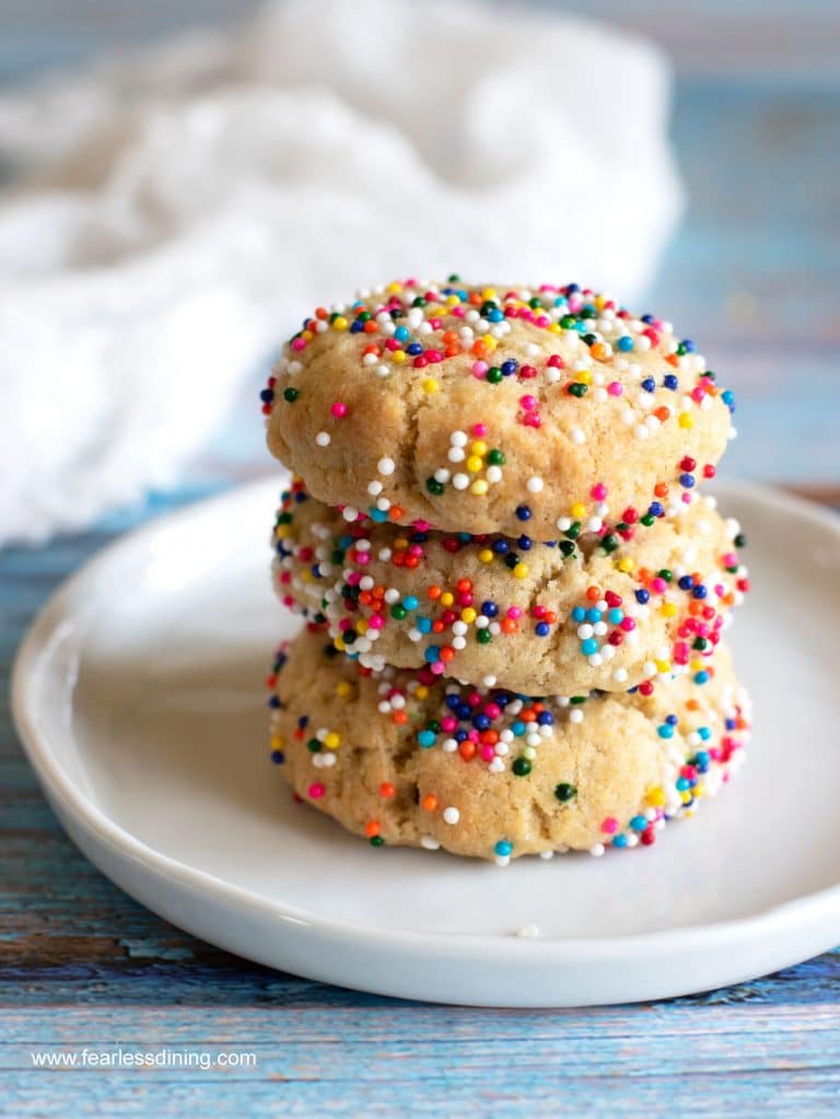 A stack of cream cheese sugar cookies with sprinkles.