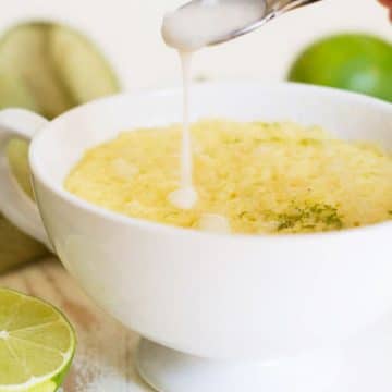 Drizzling icing over a gluten free lime mug cake.