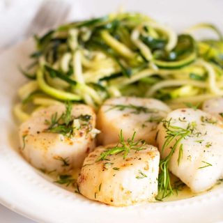 a plate of air fried scallops and zoodles with a garlic butter sauce