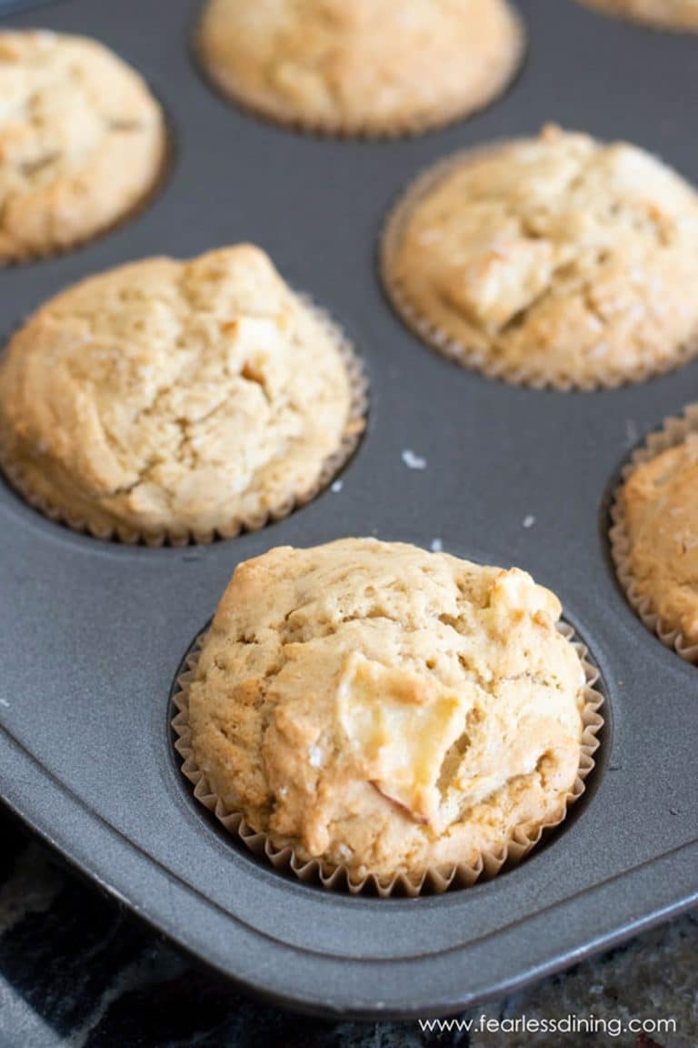 Baked gluten free apple muffins in a tin.