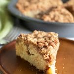 The front of a slice of gluten free coffee cake on a wooden plate.