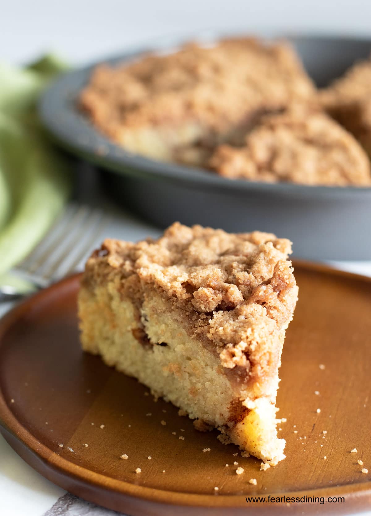 The front of a slice of gluten-free coffee cake on a wooden plate.