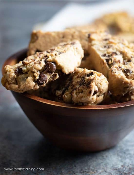 A wooden serving bowl filled with mandelbrot.