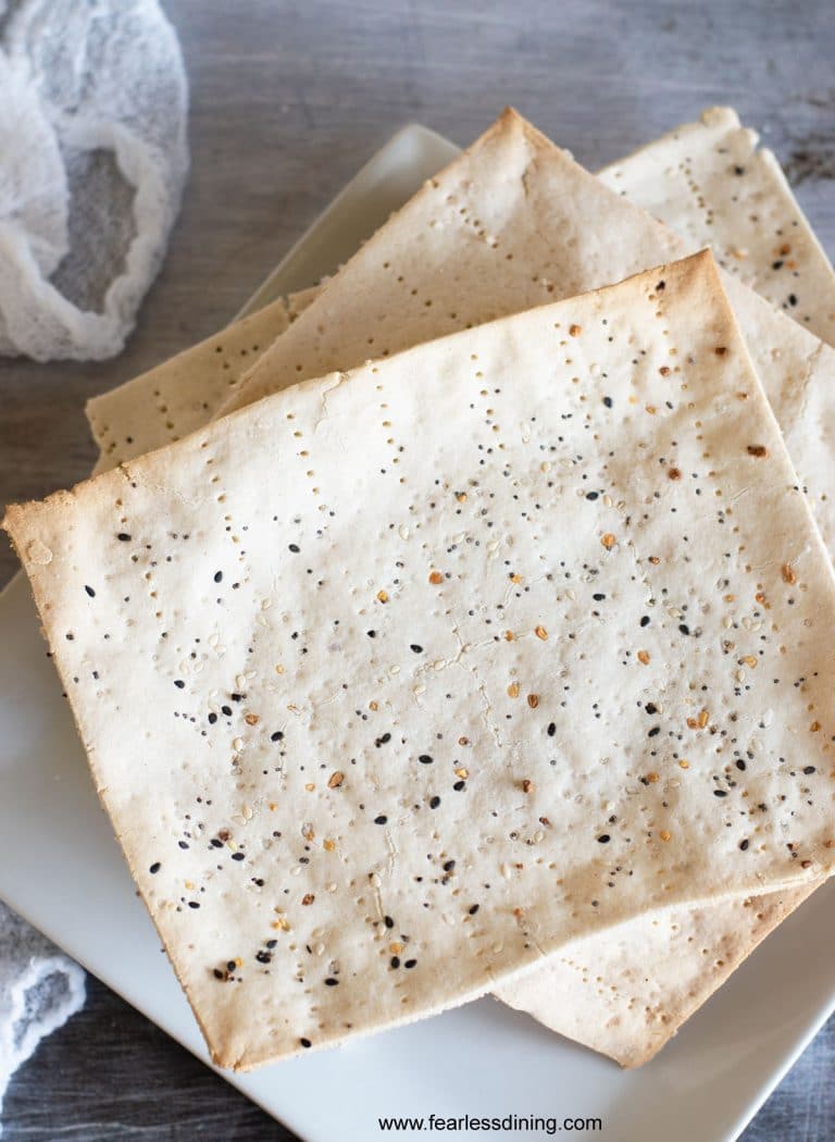 Whole pieces of homemade gluten free matzo on a plate.