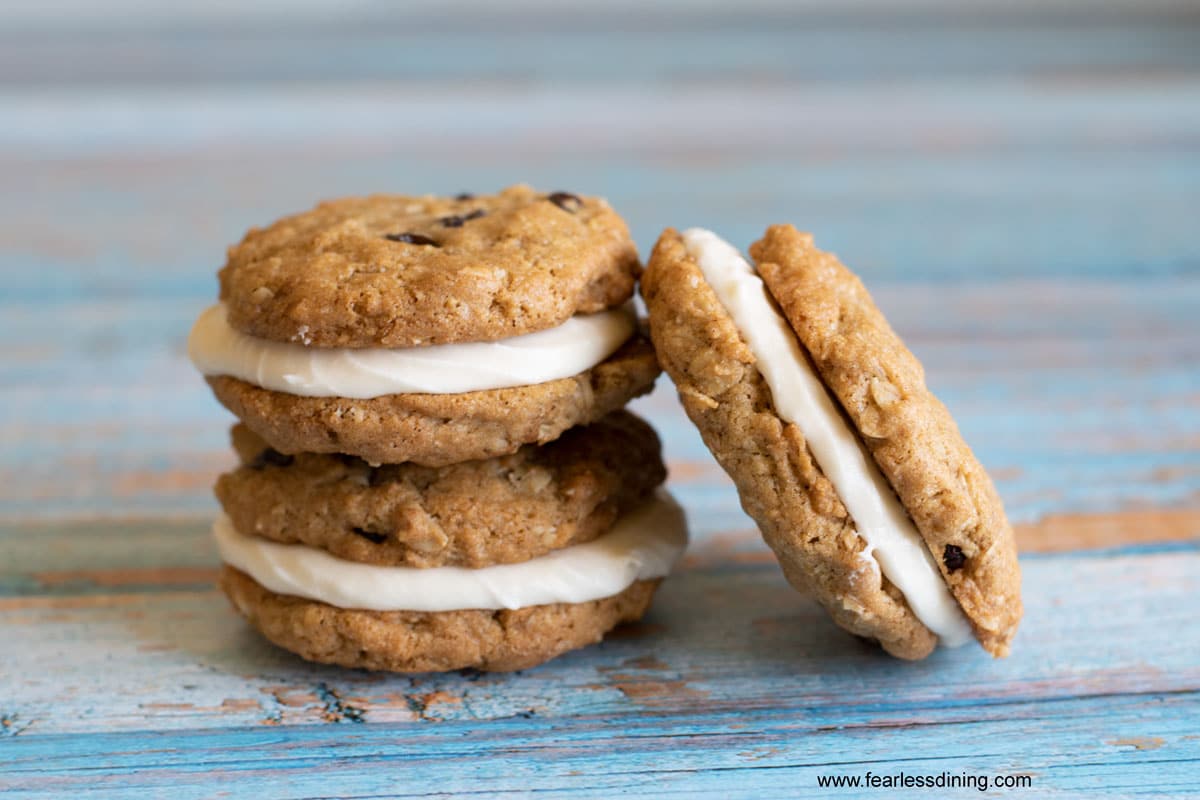 Three oatmeal cream pies on a blue table.