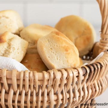 a close up of dinner rolls in a basket