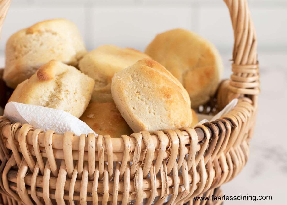 a close up of dinner rolls in a basket