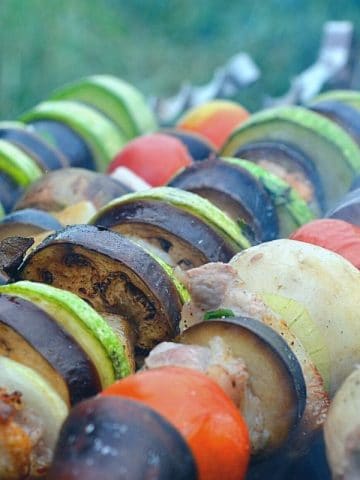 vegetables on skewers cooking on a grill