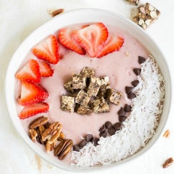 the top view of a strawberry smoothie bowl topped with strawberries