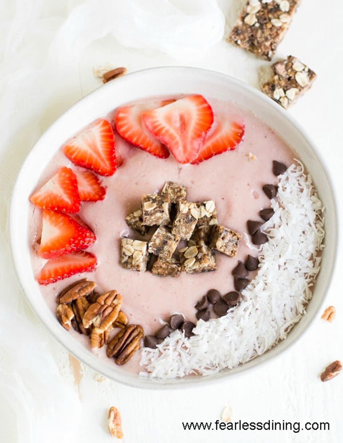 The top view of a strawberry smoothie bowl topped with strawberries.
