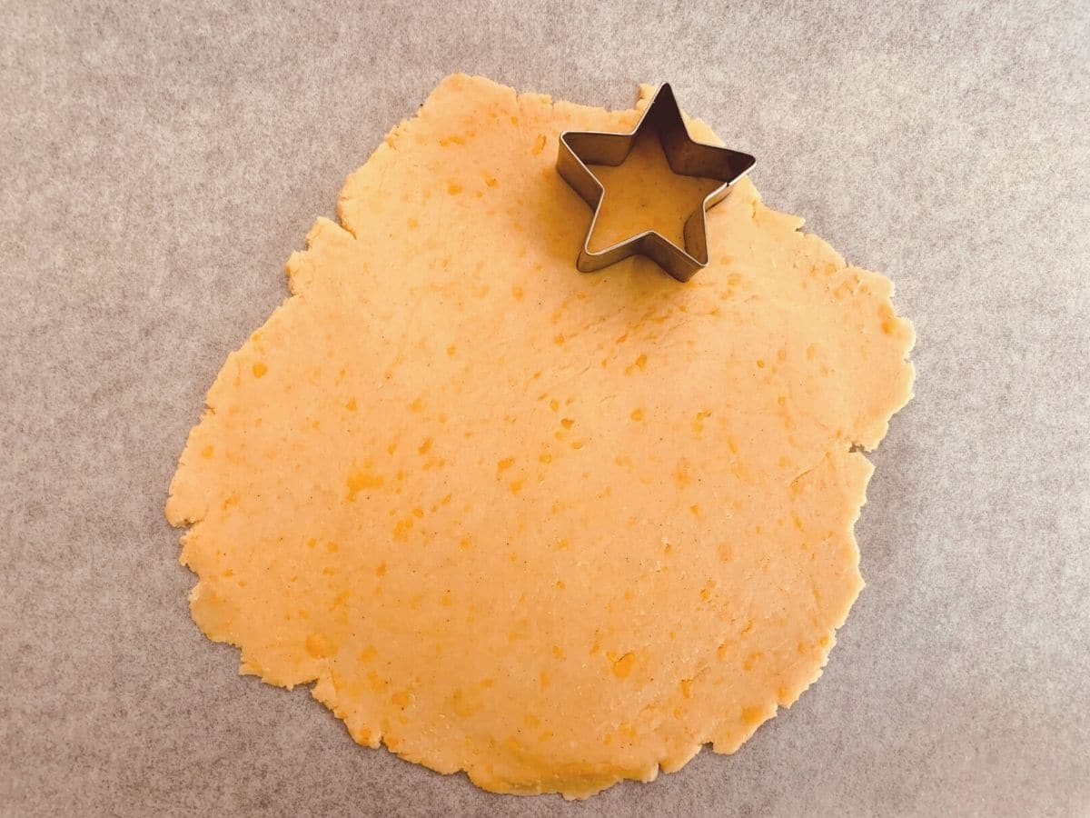Cutting out star shapes out of the cheese cracker dough.