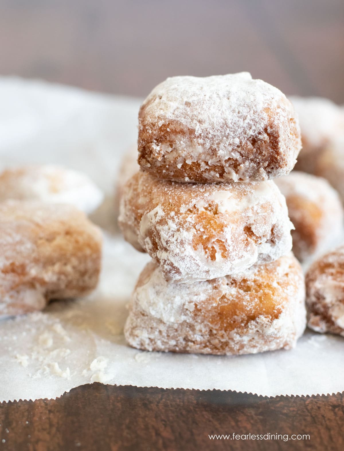 A stack of three gluten free beignets.