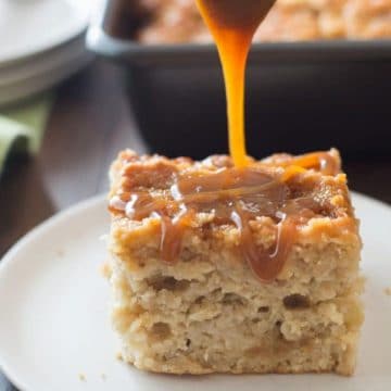A slice of caramel apple cake with caramel being drizzled over the top.