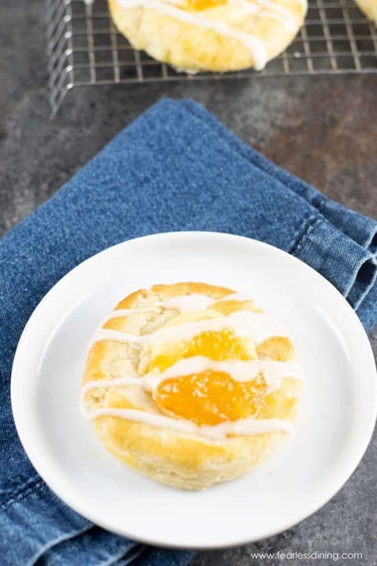 A gluten free cheese Danish on a small white plate.