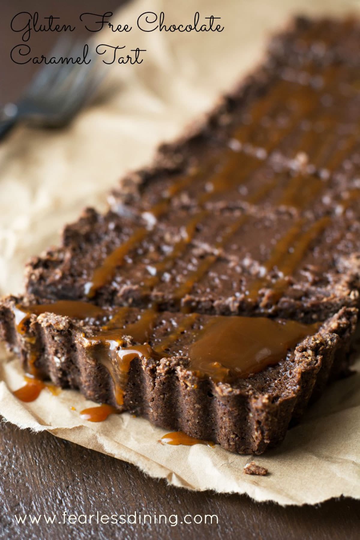 A whole gluten free chocolate tart sliced.