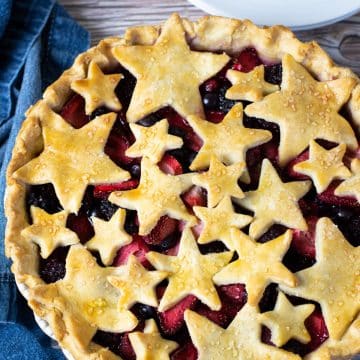 the top view looking down at a mixed berry pie. The top crust is cut into star shapes