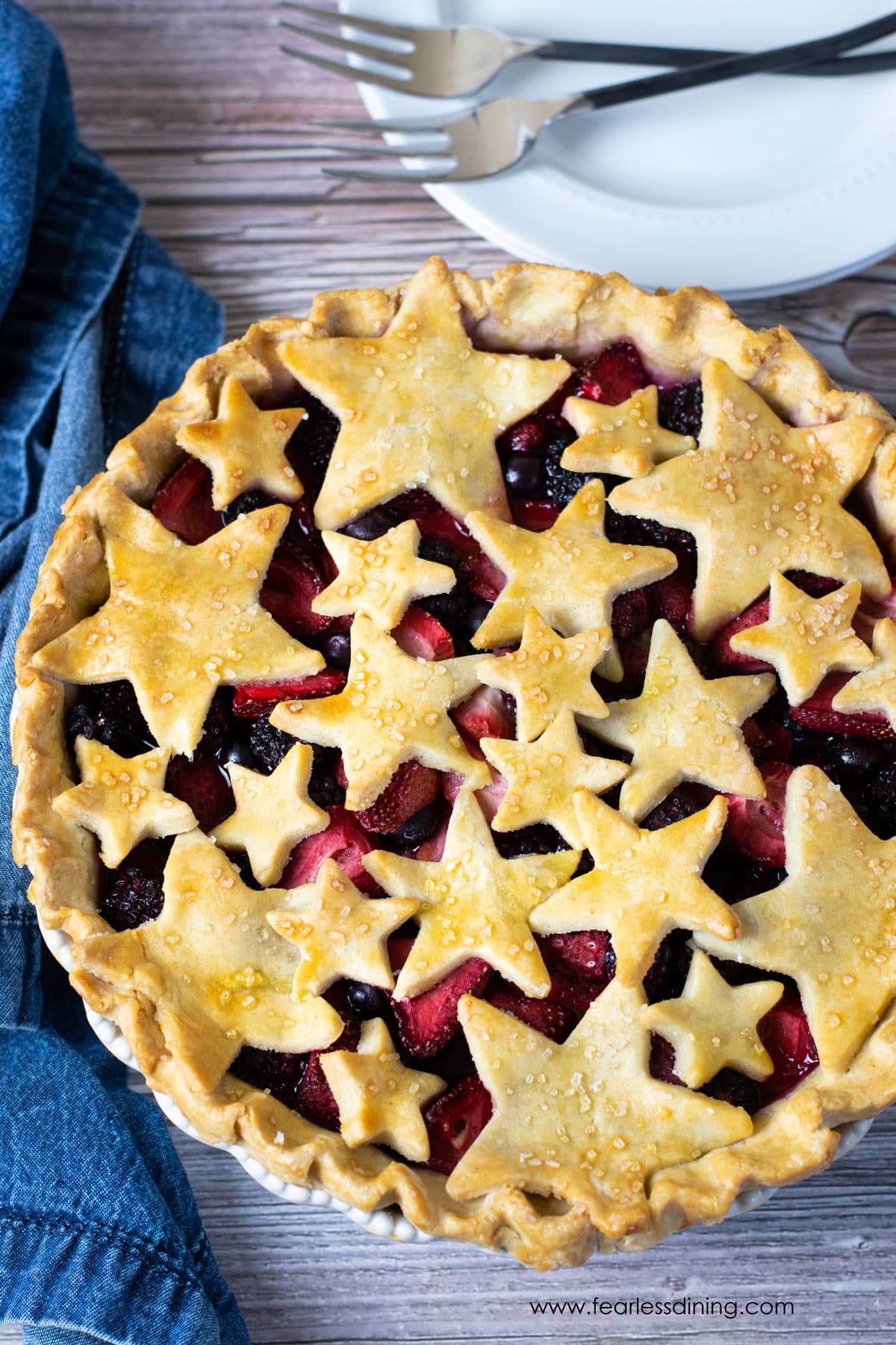 The top view looking down at a mixed berry pie. The top crust is cut into star shapes.